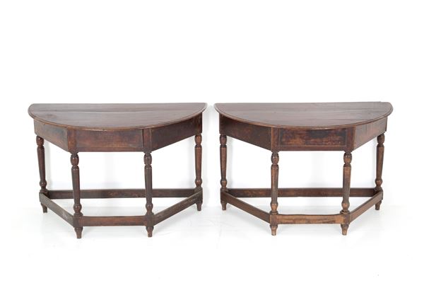Two half-moon consoles