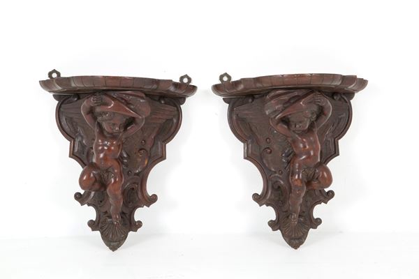 Pair of shelves with putti