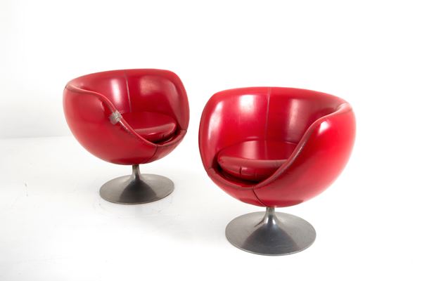 Two red swivel armchairs