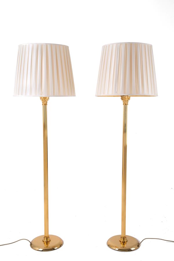 Two brass floor lamps