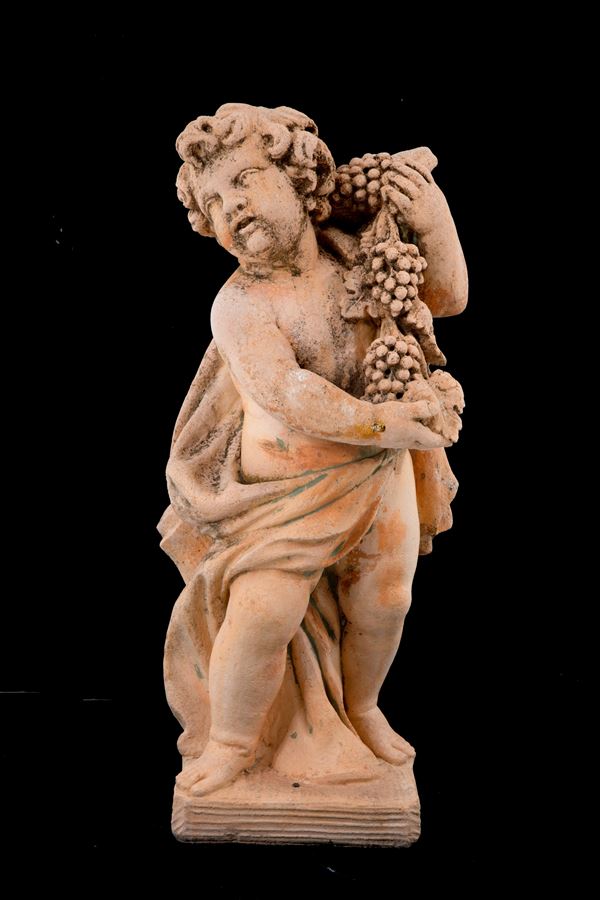 Terracotta sculpture "PUTTO WITH BUNDLES OF GRAPES"