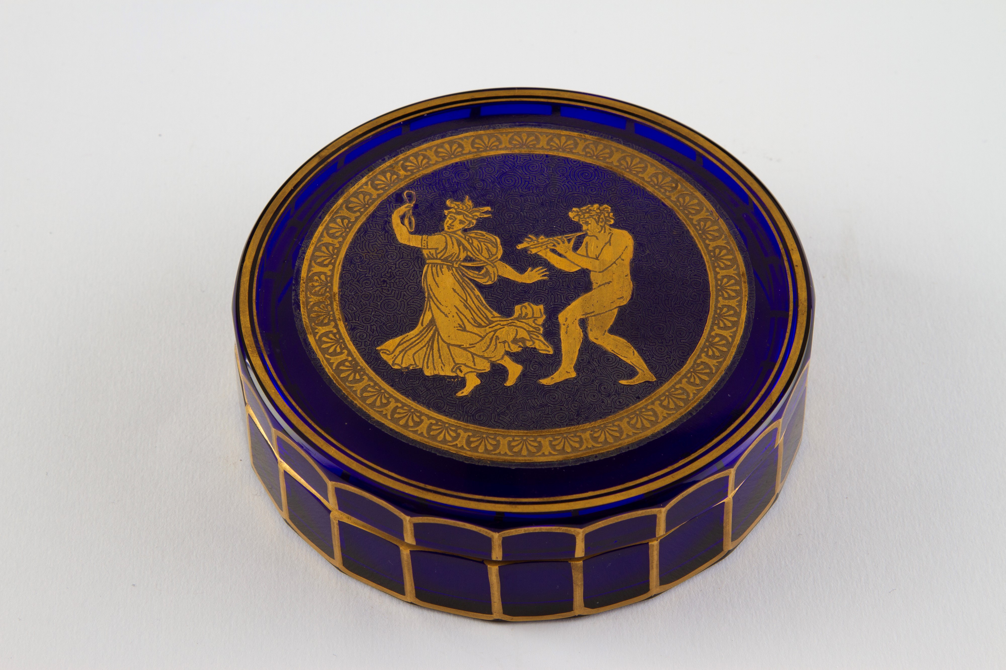 Scatola in vetro blu decorato in oro con scena di baccanale