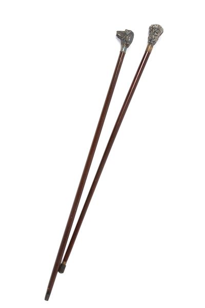 Due bastoni decorativi con impugnature a muso di segugio e floreali, legno e argento, XX secolo