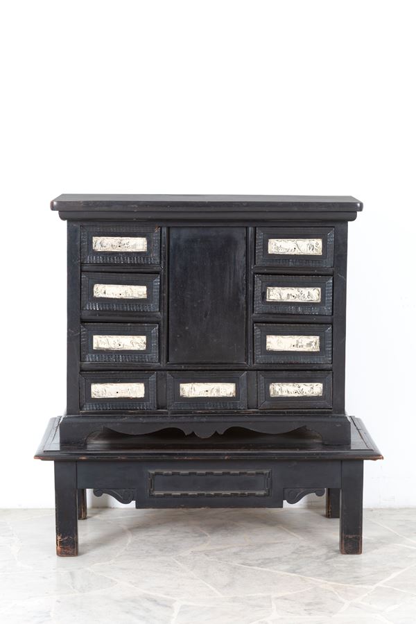 Ebonized coin cabinet