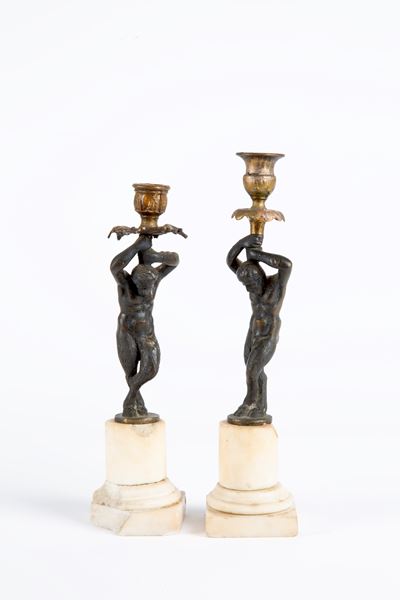 Coppia di candelieri “Satiri”, bronzo e basi in marmo bianco