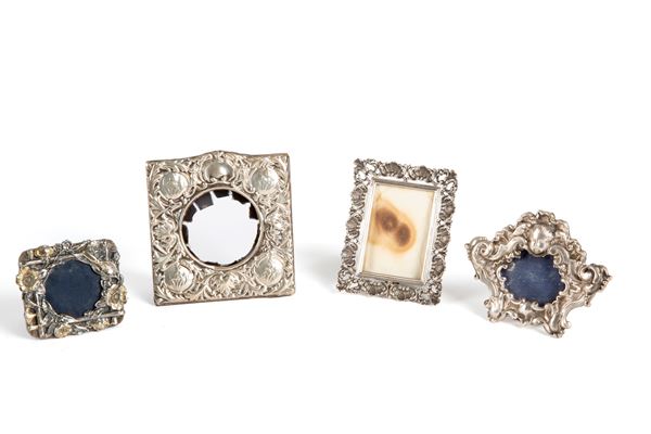 Four small silver photo frames