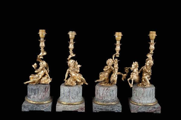 Four candlesticks with cherubs