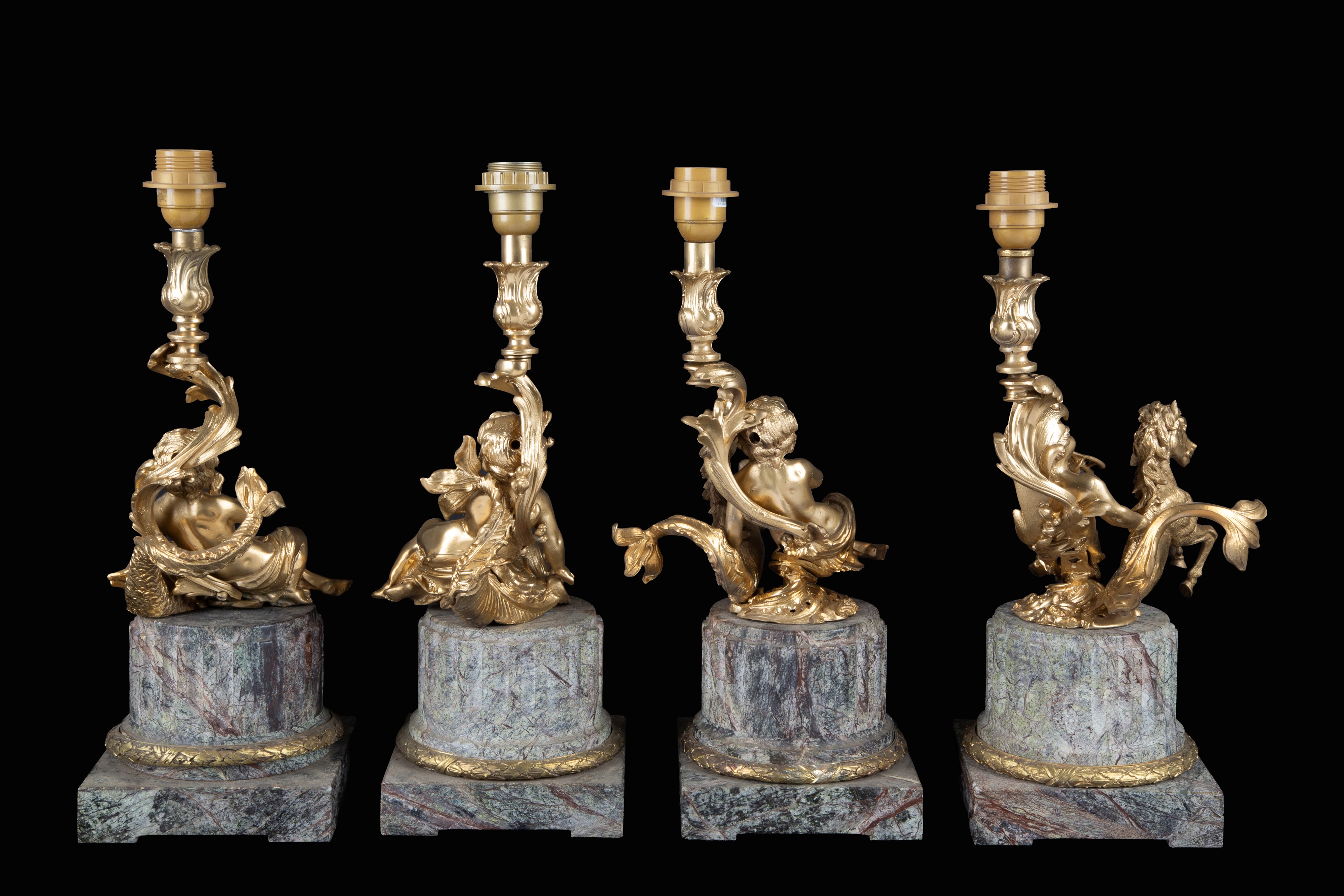 Quattro candelieri, bronzo dorato con putti musicanti e basi in marmo grigio